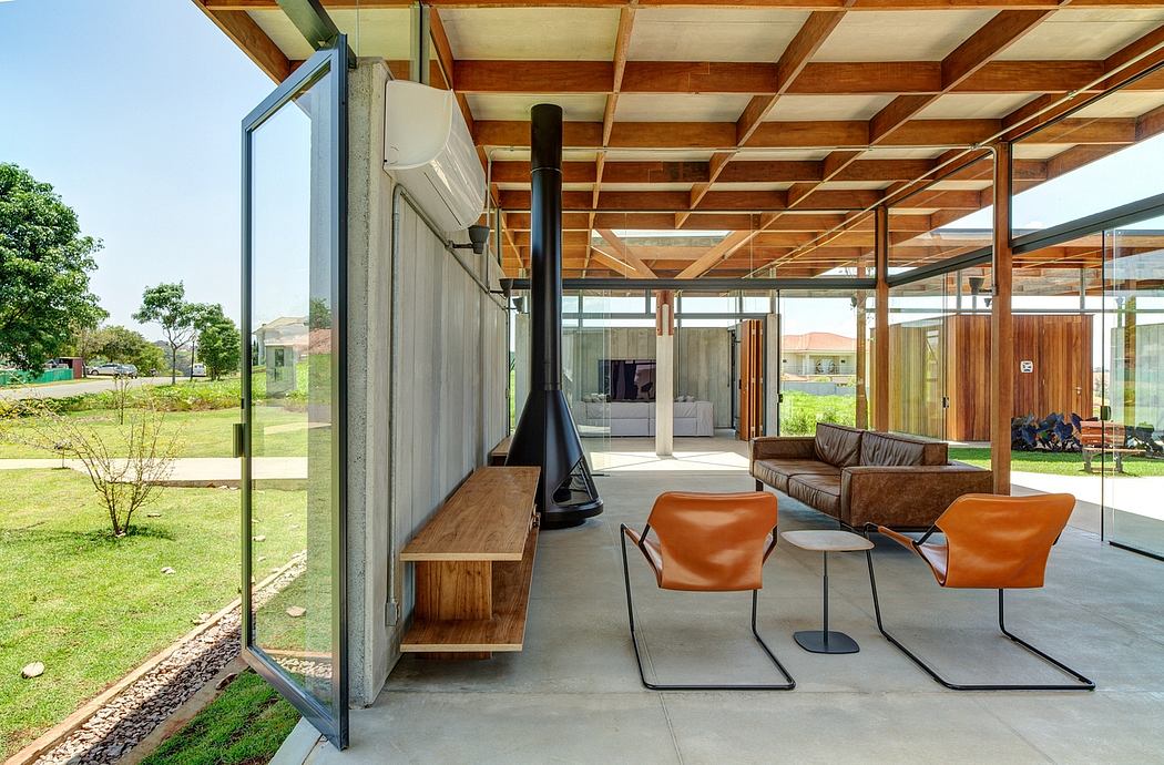 Spacious modern interior with wooden beams, glass walls, and leather furniture.