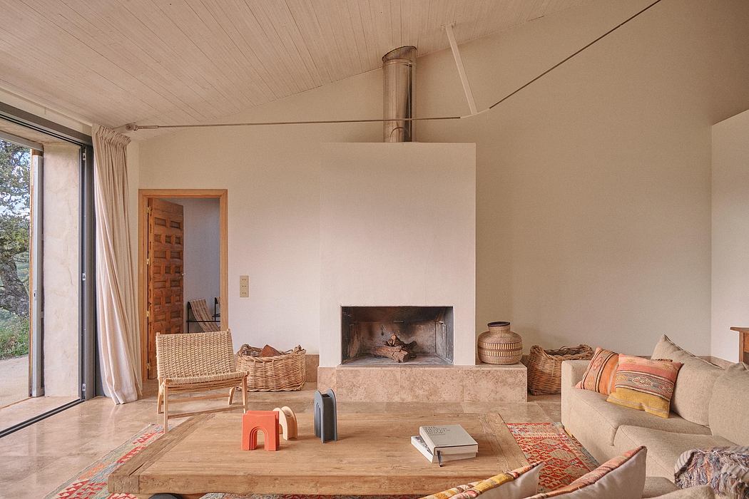 Cozy, rustic living room with wooden accents, stone fireplace, and wicker furnishings.