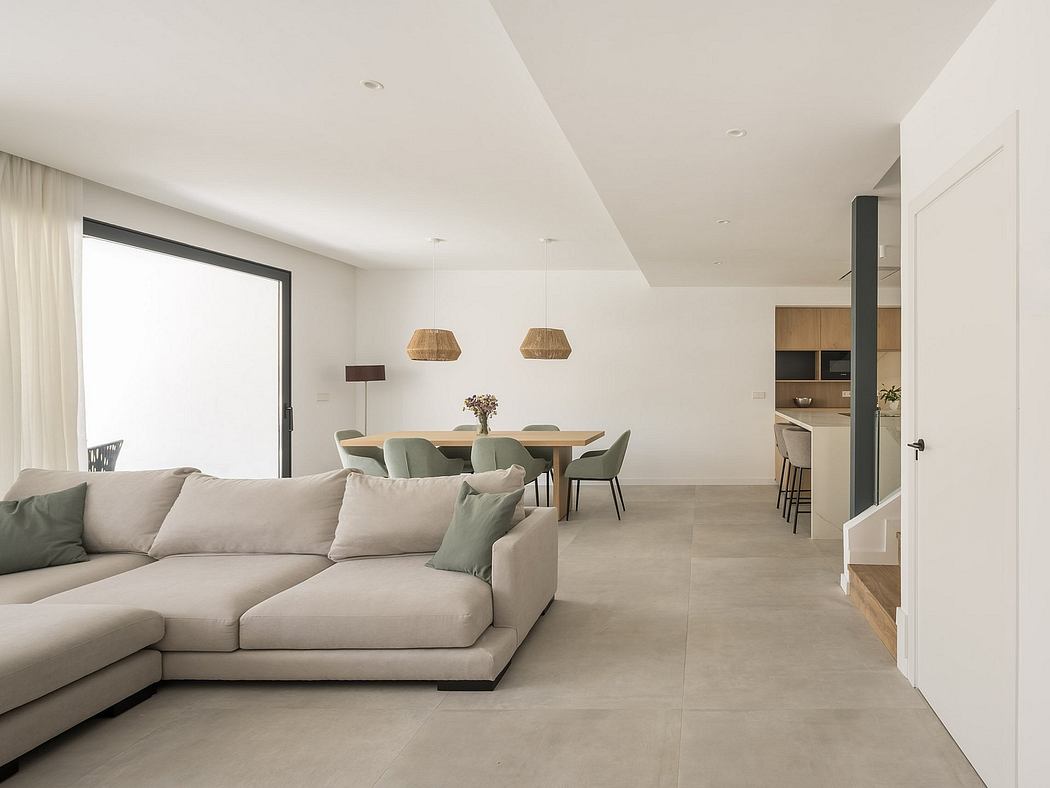Spacious, open-concept living area with minimalist furnishings and modern, neutral color palette.