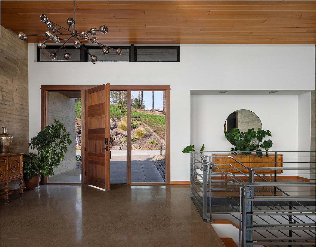 Minimalist interior with natural wood, modern lighting, and views to the outdoors.