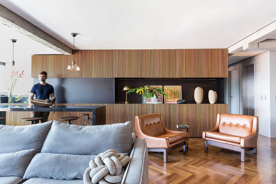 Modern living room with wooden paneled walls, built-in shelving, and leather armchairs.