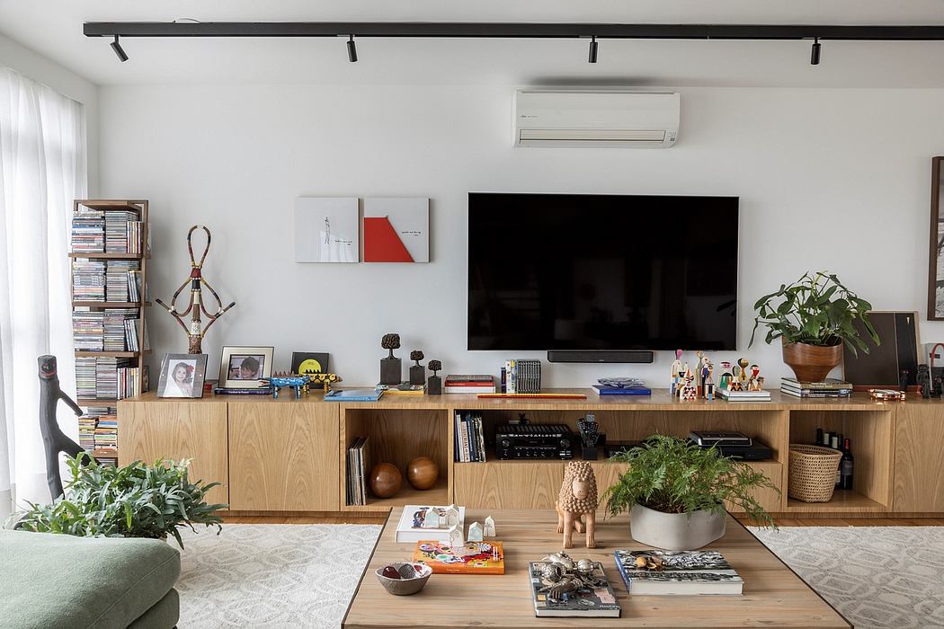 Warm, modern living space with wooden entertainment center, potted plants, and artwork.