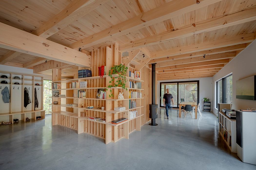 Expansive wooden interior with a custom bookshelf divider and open floor plan.