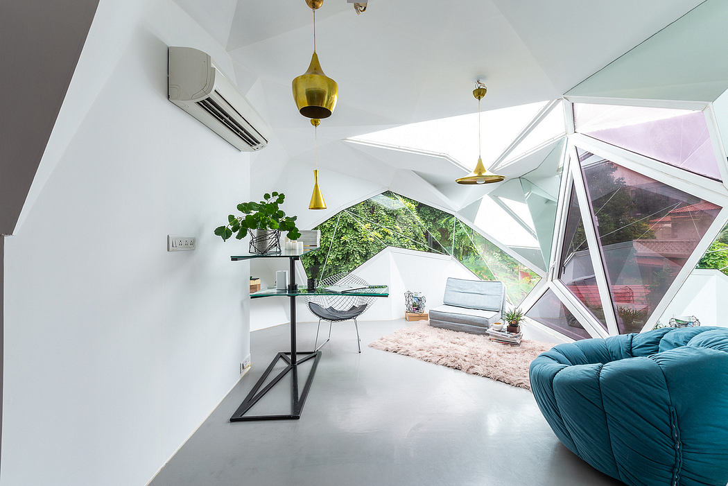 Modern interior with geometric glass walls, cozy seating, and hanging lamps.