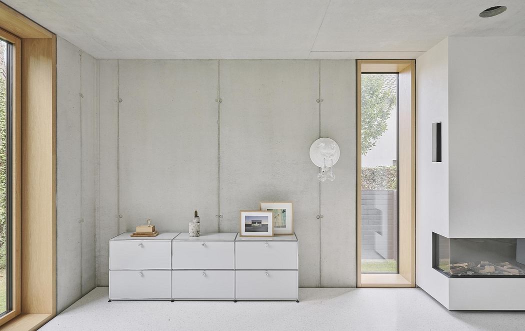 Minimalist interior with concrete walls, modular storage units, and a large window.