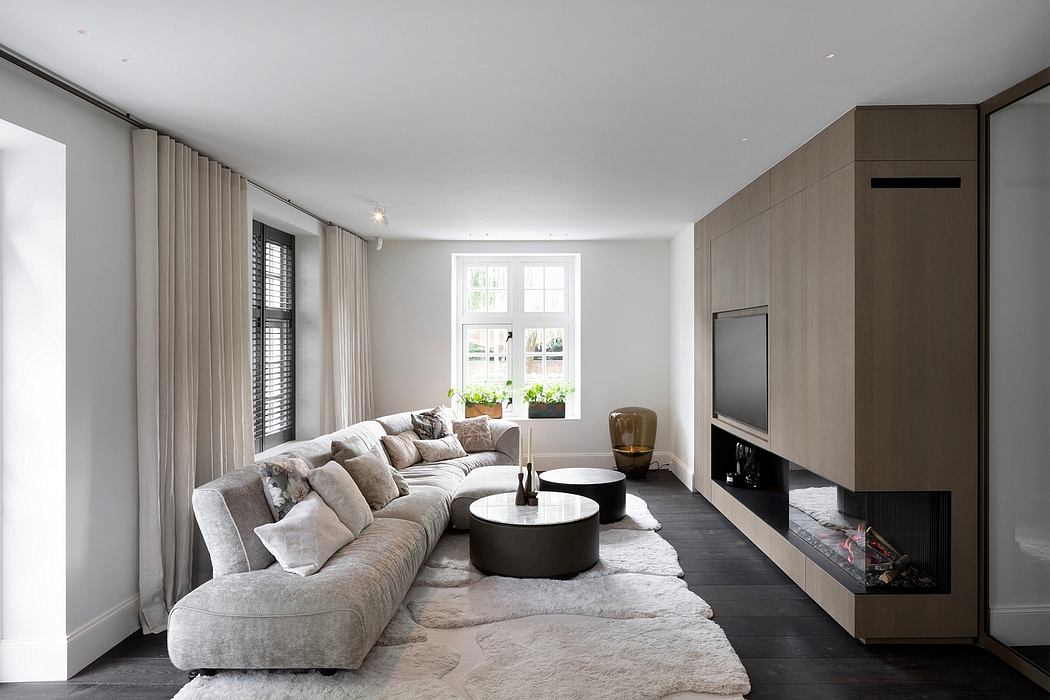 Spacious, modern living room with large sectional sofa, round coffee tables, and fireplace.