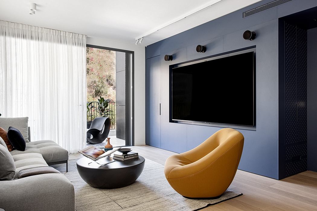 Sleek modern living room with large TV, plush seating, and contemporary decor.
