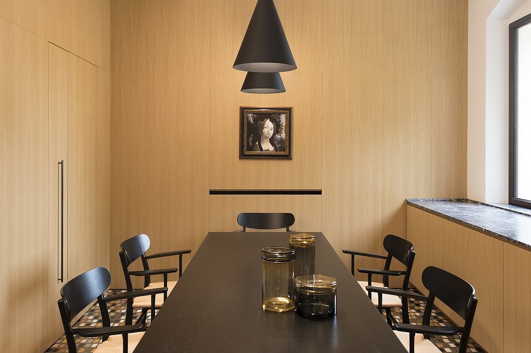 Well-designed modern dining area with sleek black lighting, wooden walls, and stylish furniture.
