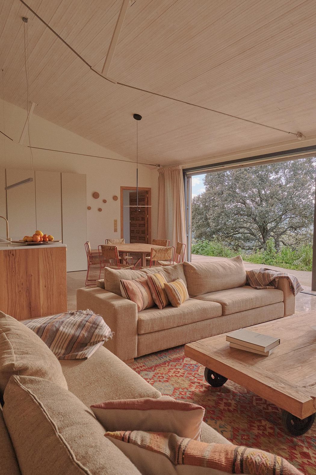 A cozy and inviting living space with wooden furnishings, patterned accents, and a scenic view.