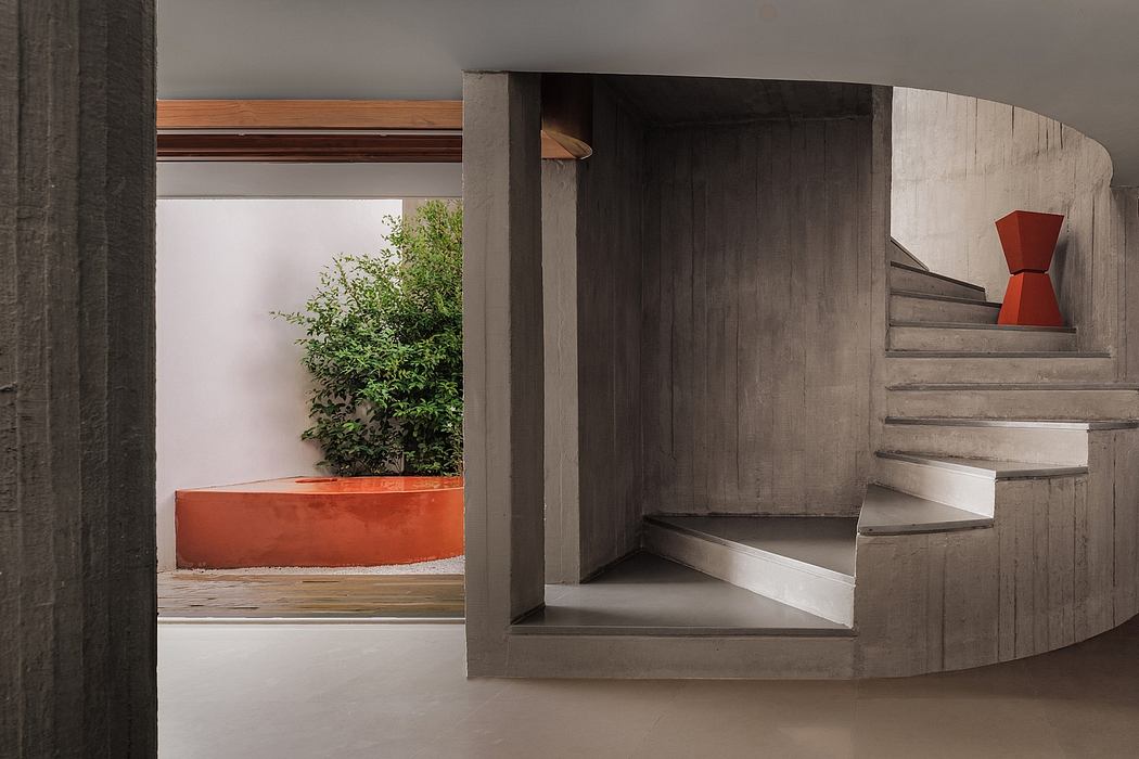 A modern, minimalist architectural design featuring concrete stairs, wooden accents, and a vibrant orange planter.