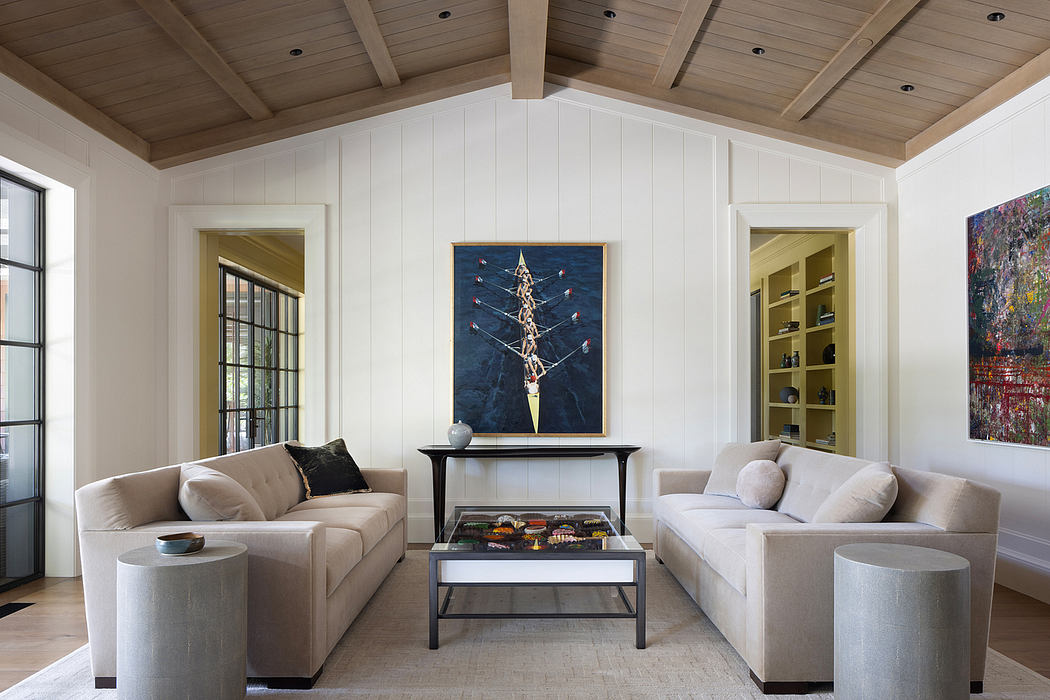 Spacious living room with white walls, wooden ceiling, and modern furnishings.