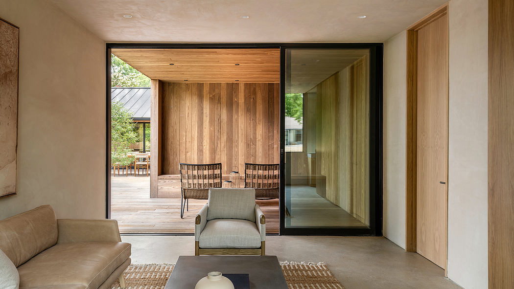 Warm-toned wood paneling, sleek glass walls, and comfy seating create a modern, inviting space.