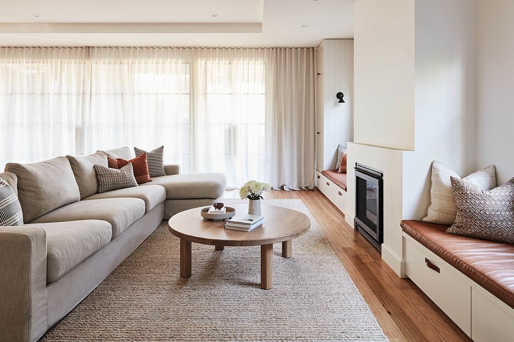 Elegant modern living room with neutral palette, plush sectional, and wood accents.
