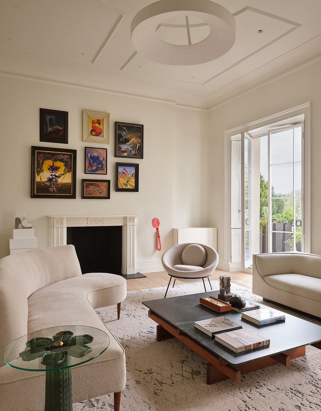 Elegant living room with intricate ceiling details, artwork, and modern furniture.