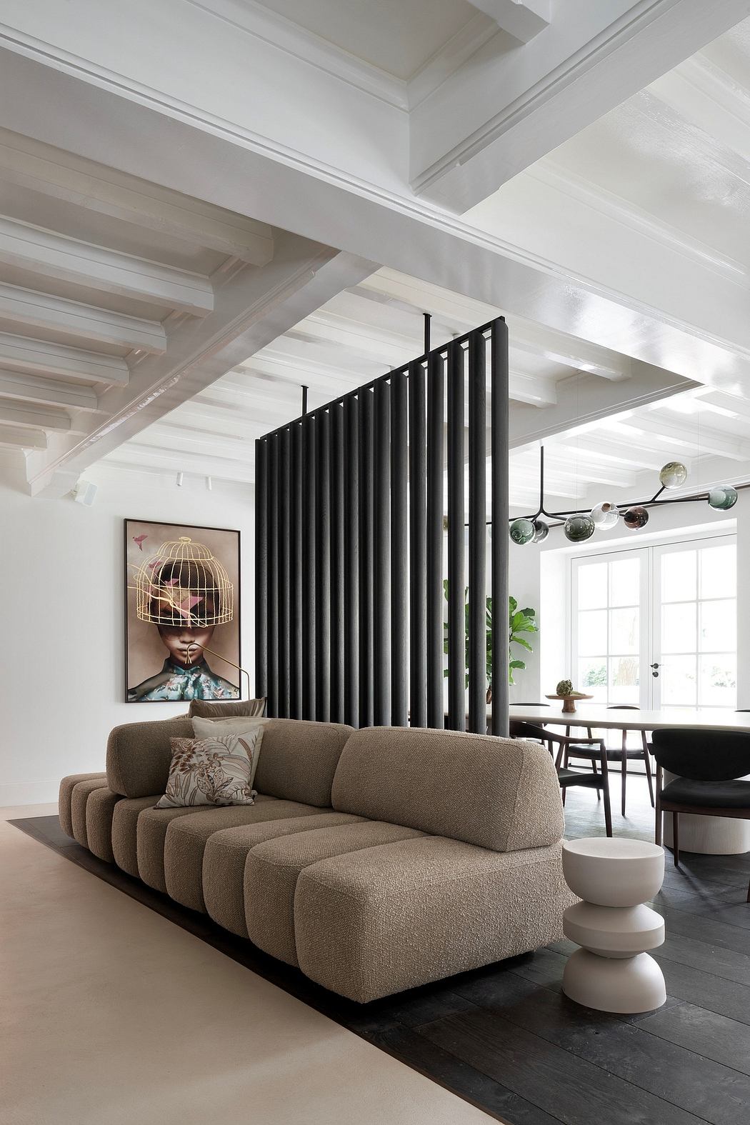 Spacious, modern room with a large brown sectional sofa and intricate lighting fixture.