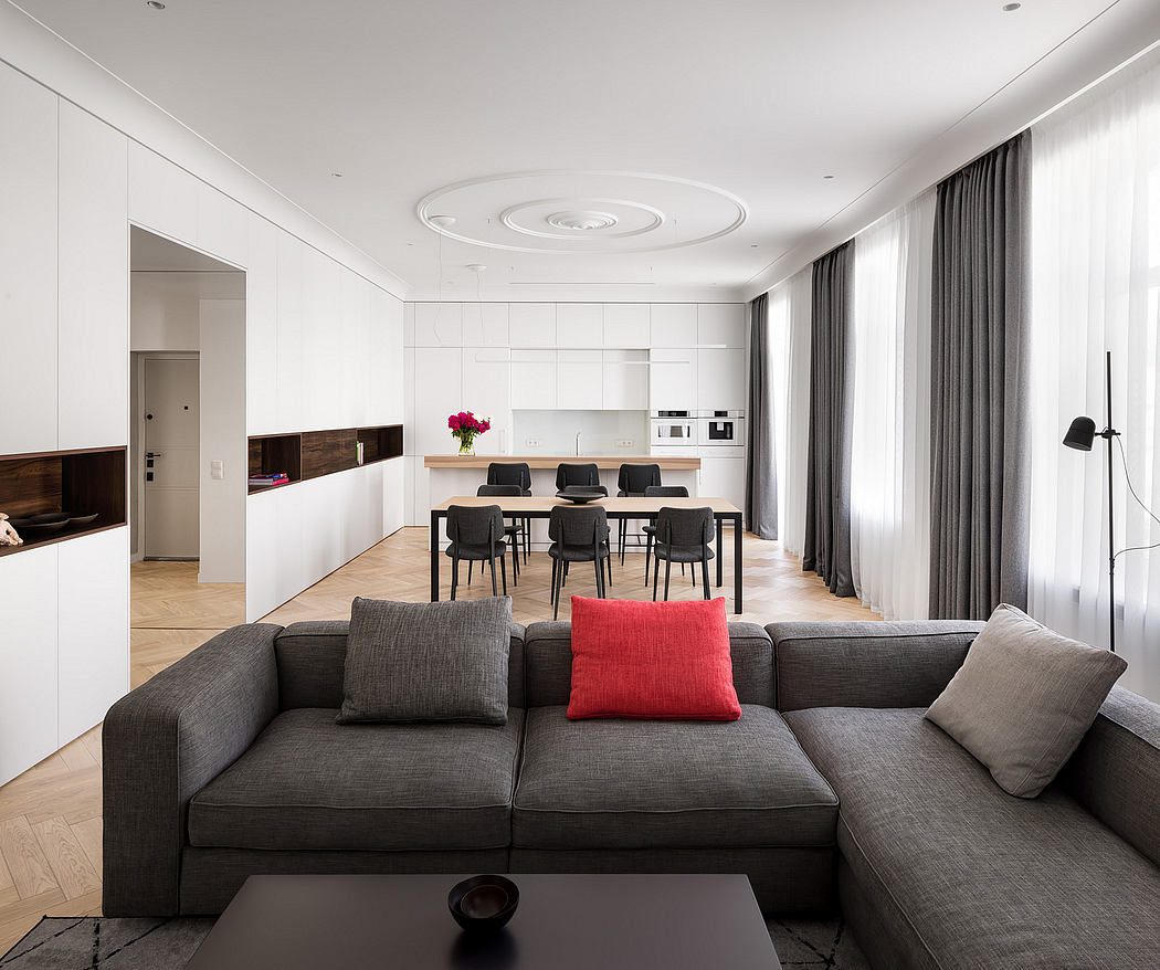 Bright, modern living space with sleek, minimalist furniture and circular ceiling design.