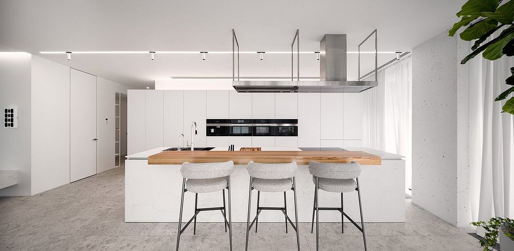 Minimalist kitchen with a large wooden counter, white cabinets, and industrial-style lighting.