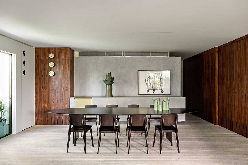 Sleek contemporary dining room with warm wood accents, minimalist decor, and recessed lighting.