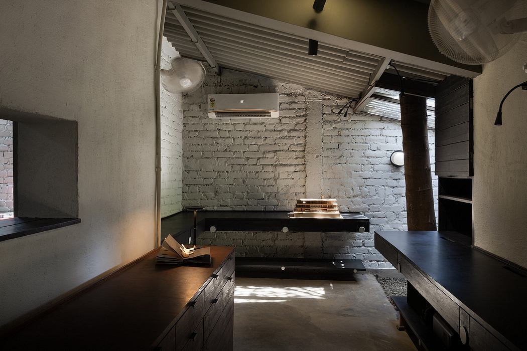 Exposed brick walls, wood and metal furnishings, minimalist design, and ambient lighting.