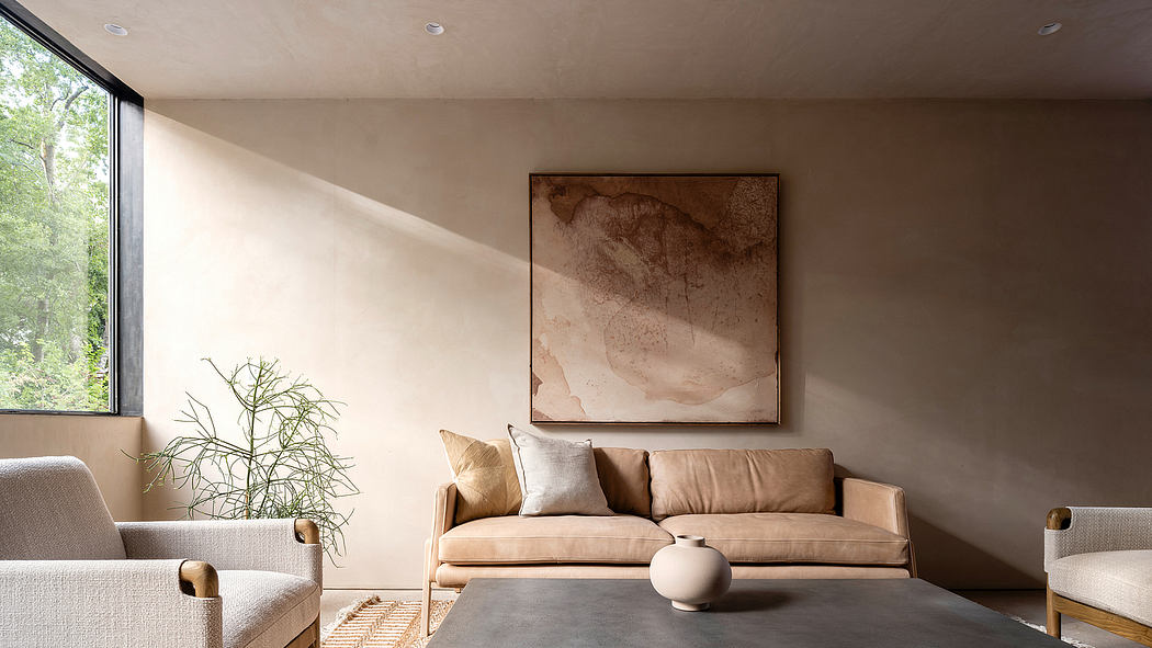 Minimalist living room with large abstract artwork, neutral tones, and natural elements.