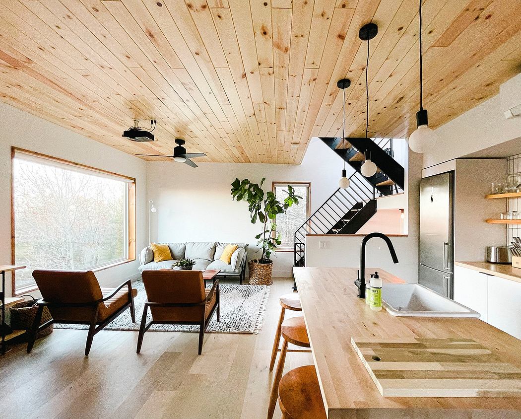 Wooden ceiling, open-plan interior with modern furniture and minimalist style.
