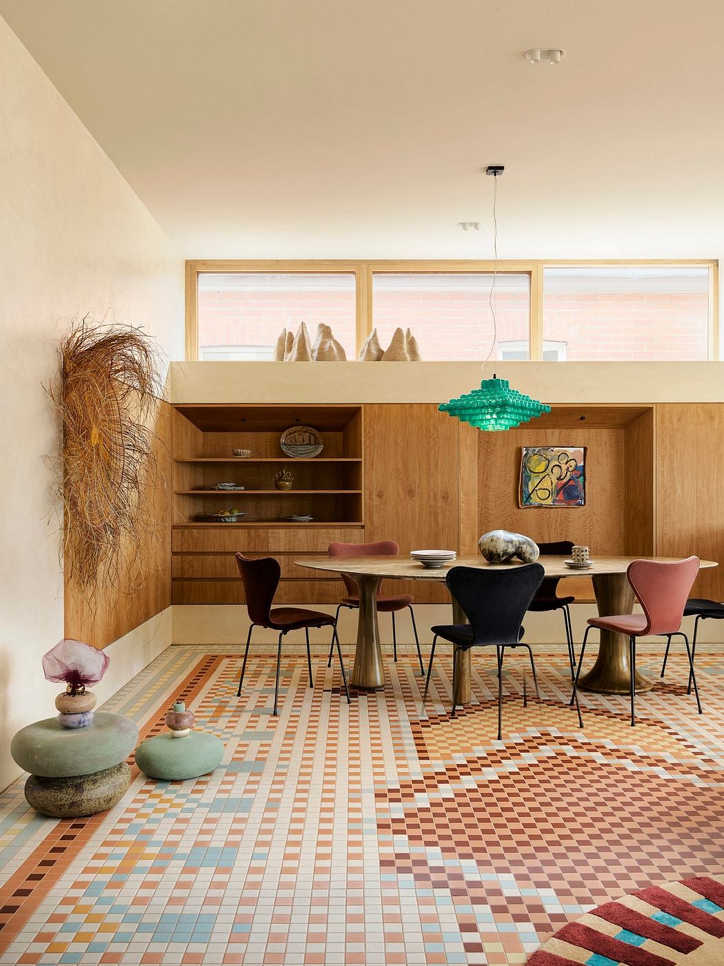 Warm-toned, mid-century modern dining area with textured furnishings and vibrant geometric tiles.