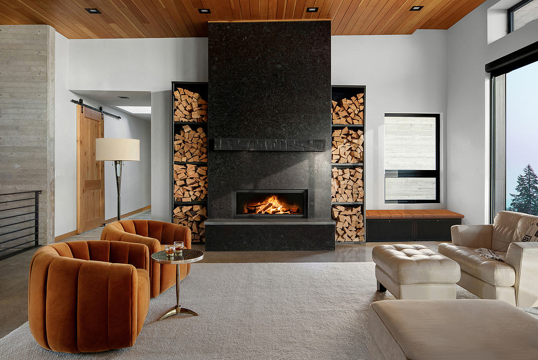 Cozy living room with a sleek fireplace, wooden ceiling, and contemporary furnishings.