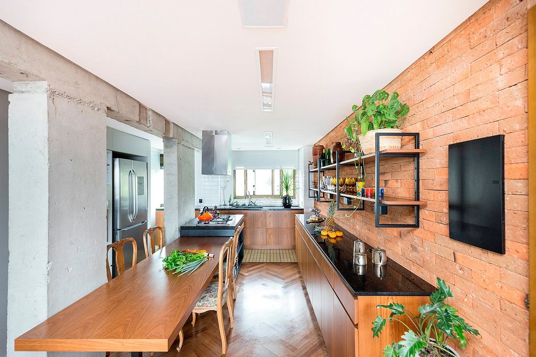 Modern open-concept kitchen with brick walls, wooden cabinetry, and sleek appliances.