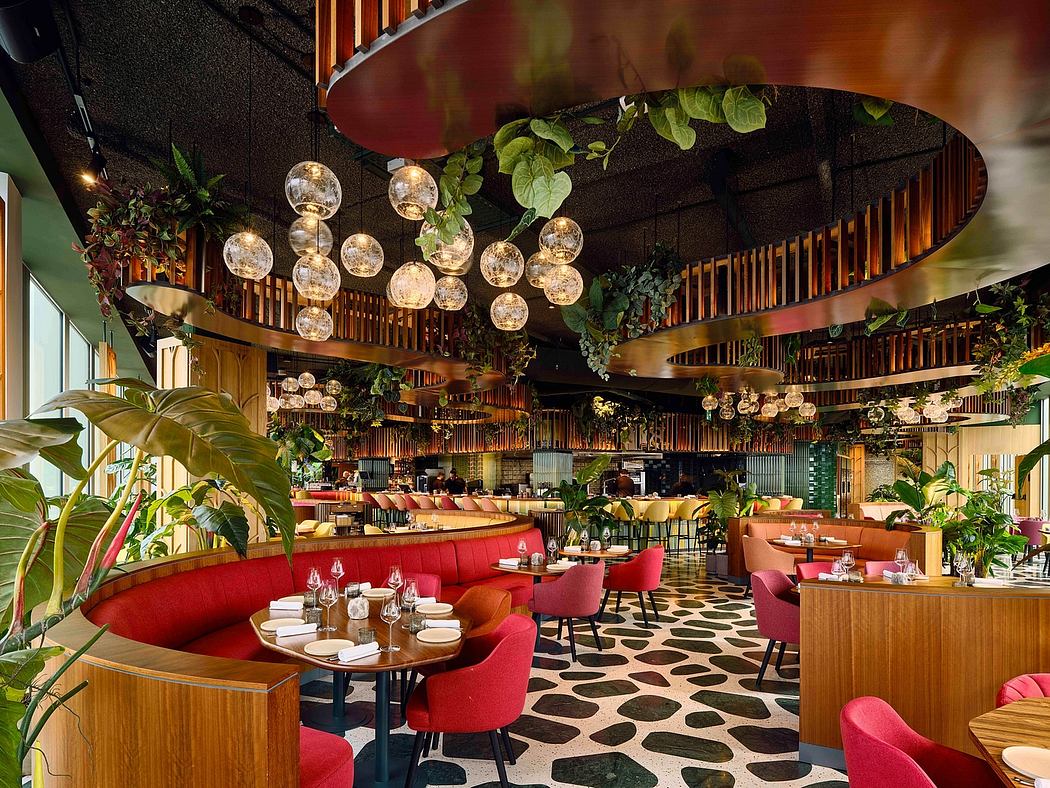 A vibrant, tropical-inspired restaurant interior with lush plants, ornate lighting, and bold patterns.