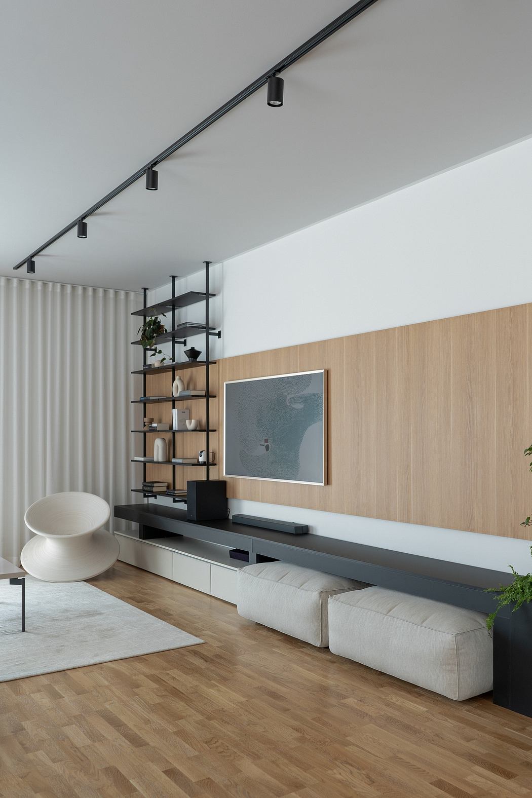 Modern living room with minimalist design, wood paneling, and sleek entertainment unit.