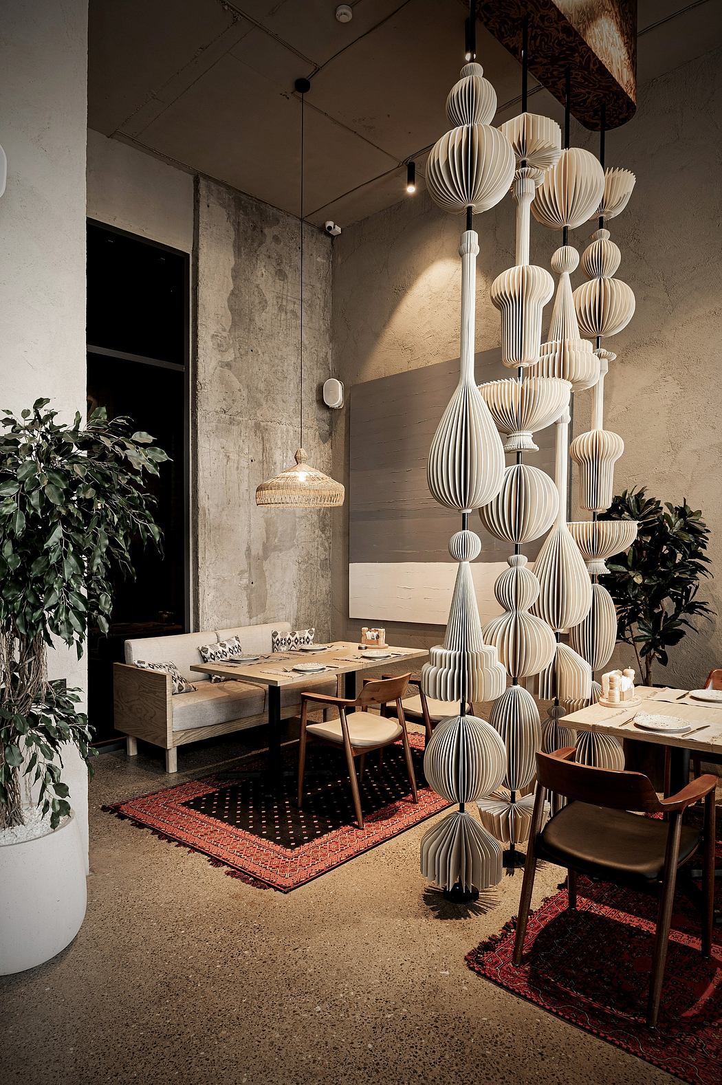 Striking architectural details with intricate paper lanterns in a contemporary cafe setting.