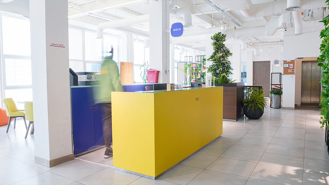 A vibrant, modern office space with colorful furniture and natural elements.