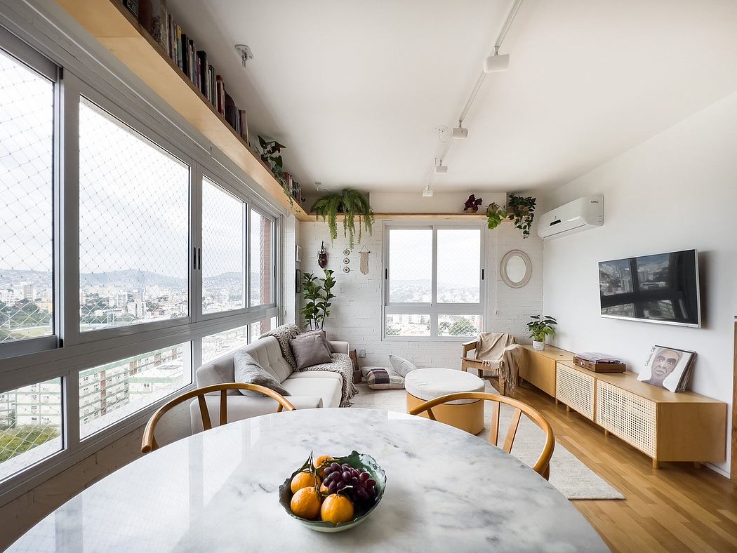 Bright, modern living space with marble dining table, cozy furniture, and scenic city view.