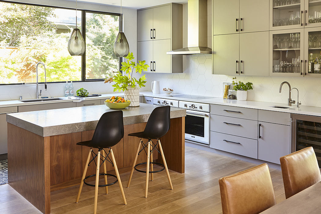 Sleek, modern kitchen with wooden island, pendant lights, and minimalist cabinetry.