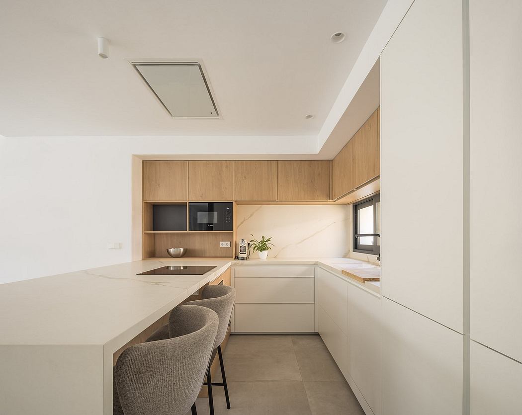 Modern kitchen with sleek wooden cabinets, light countertops, and built-in appliances.