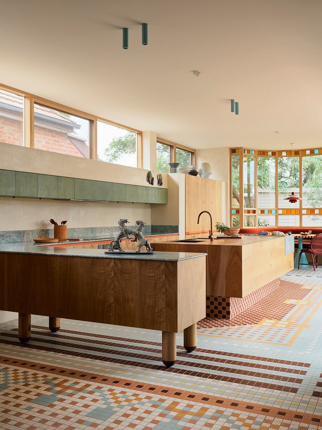 Bright, open kitchen with modern wooden cabinetry, mosaic tile floor, and large windows.