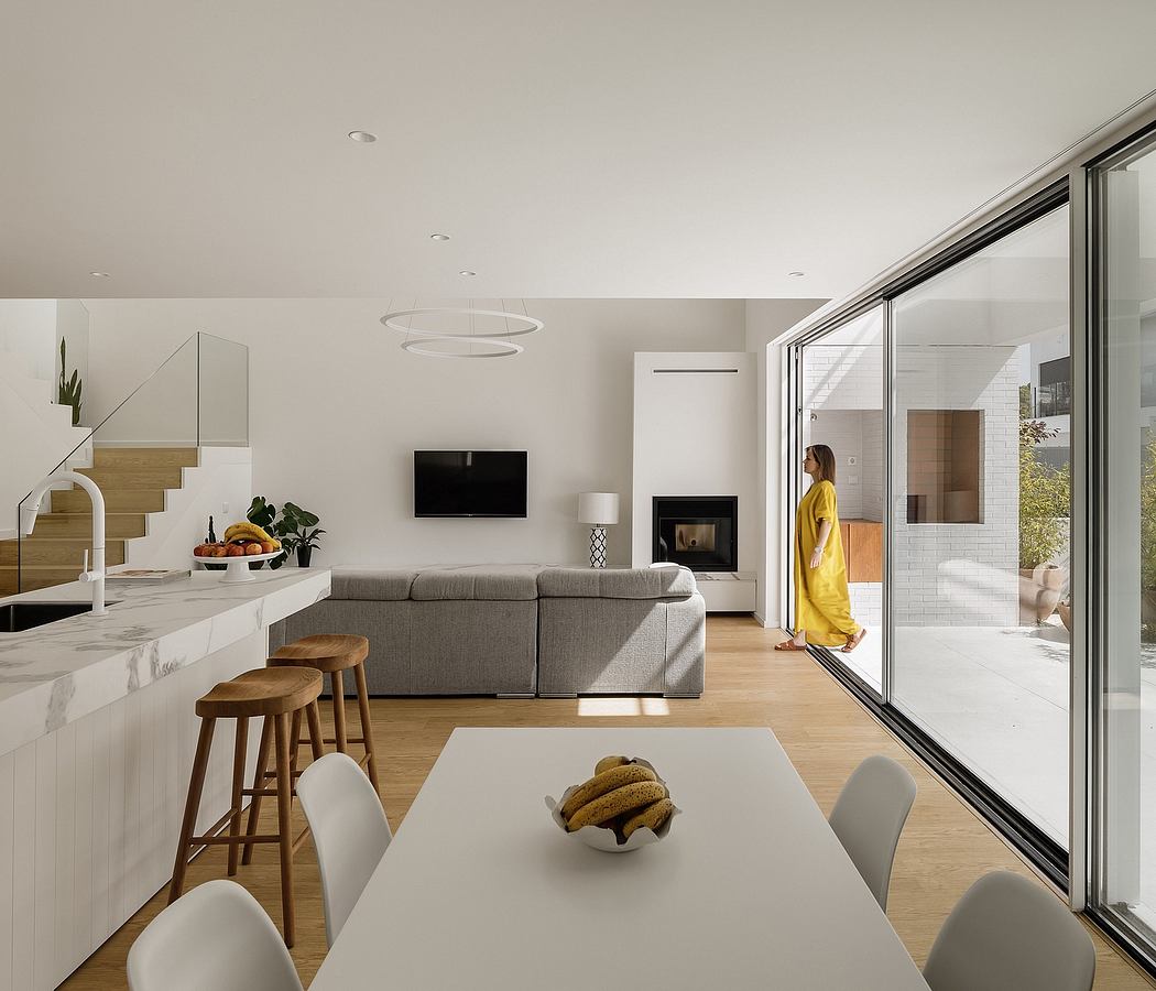 Spacious modern interior with minimalist furniture, large windows, and balanced lighting.