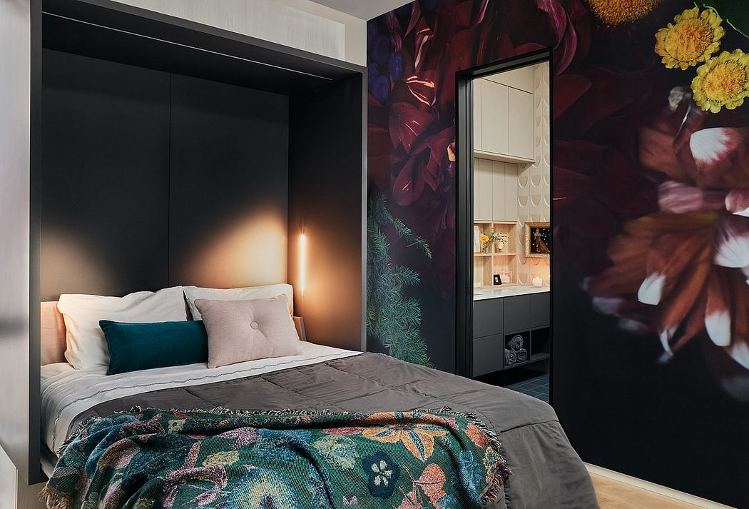 Warm, cozy bedroom with moody floral wallpaper, built-in storage, and chic decor.
