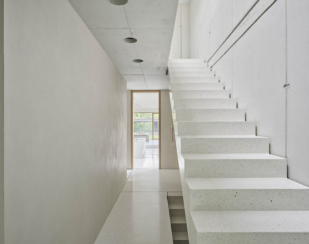 Minimalist staircase with clean, concrete steps leading to a bright open space.