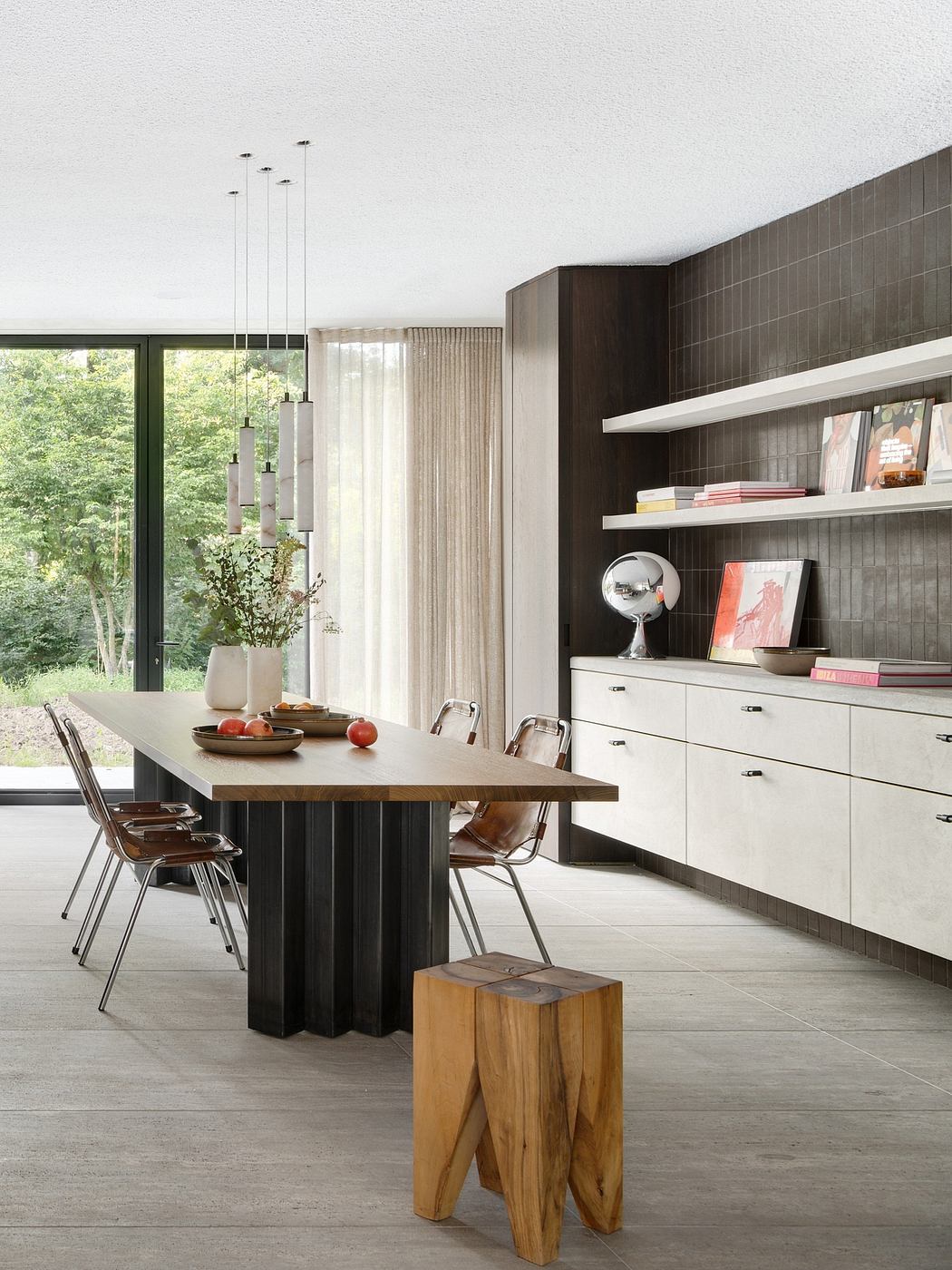 Sleek, modern kitchen with minimalist shelving, wood table, and geometric pendant lights.