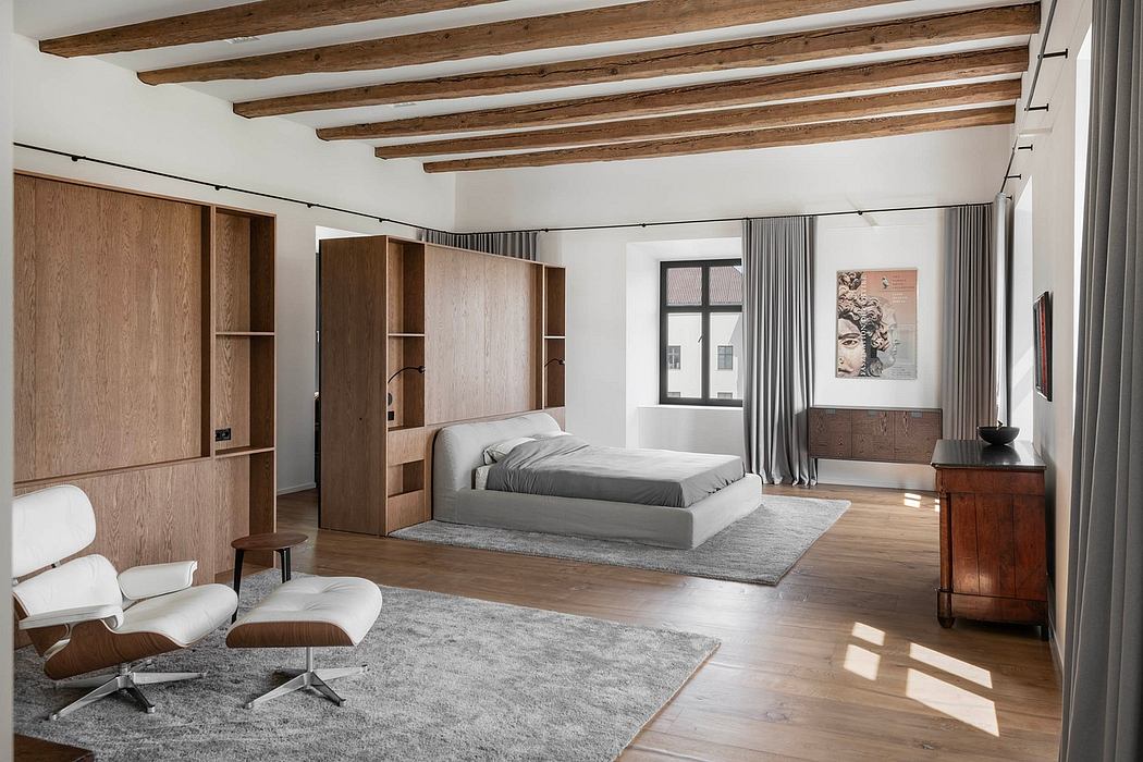 Spacious bedroom with exposed wood beams, modern built-in storage, and comfortable furnishings.