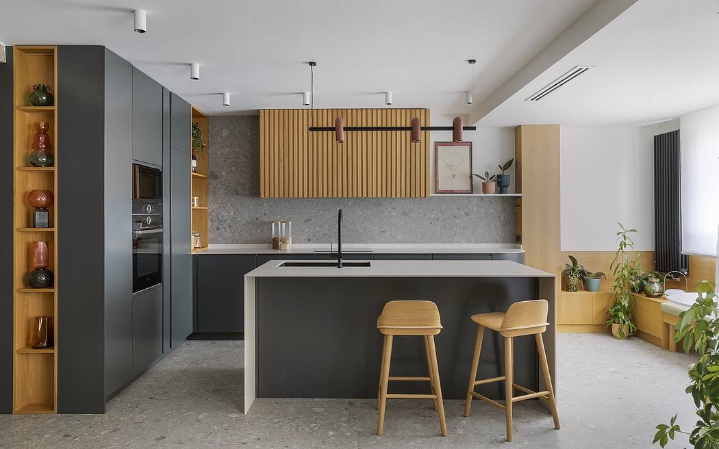 Modern kitchen with black cabinetry, concrete countertops, and wood accents. Sleek and minimalist design.