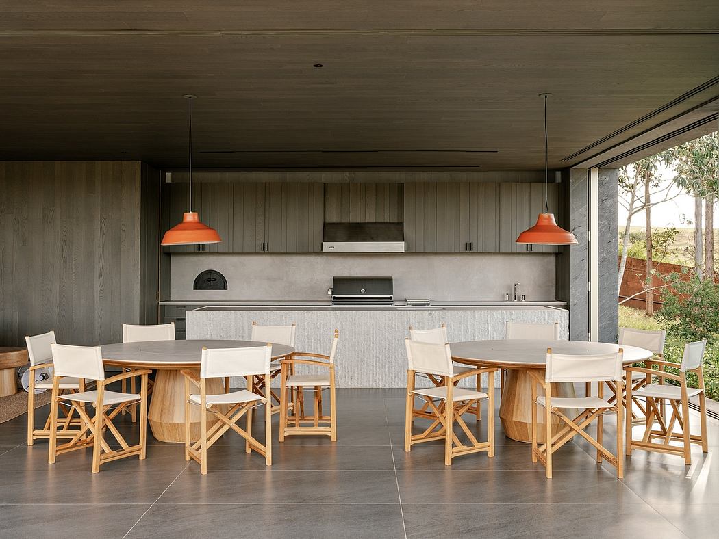Rustic outdoor kitchen and dining area with wooden furniture and warm lighting.