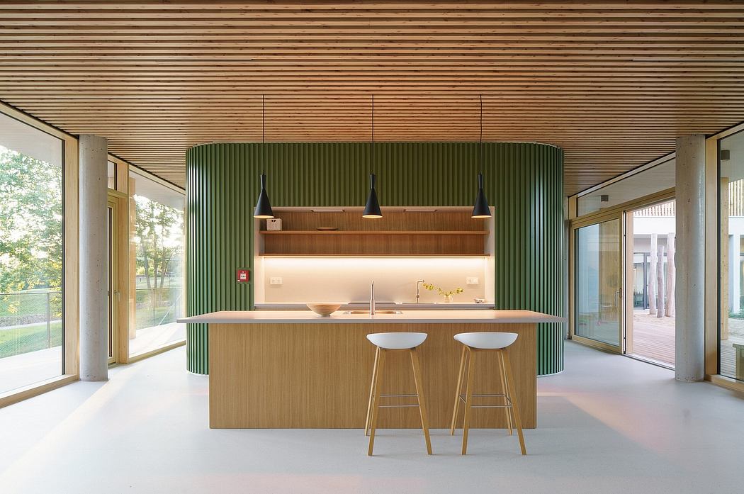Minimalist kitchen design with wood paneling, pendant lights, and bar stools.