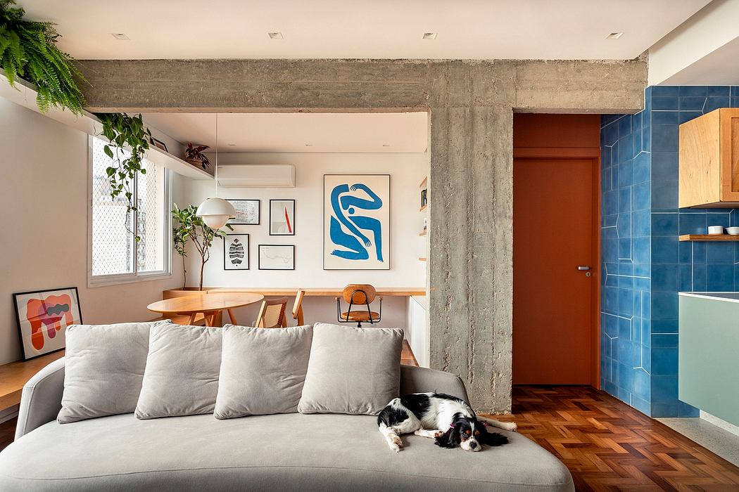 Loft-style apartment with concrete beams, modern art, and colorful tile kitchen.