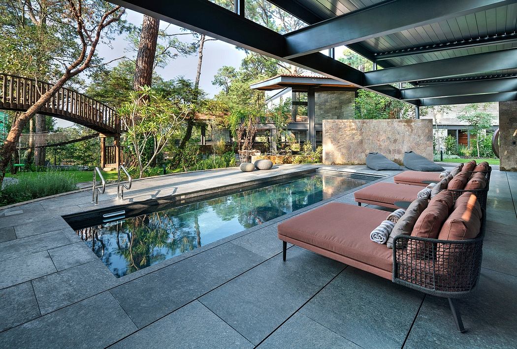 Stunning modern outdoor living space with pool, comfortable seating, and lush greenery.