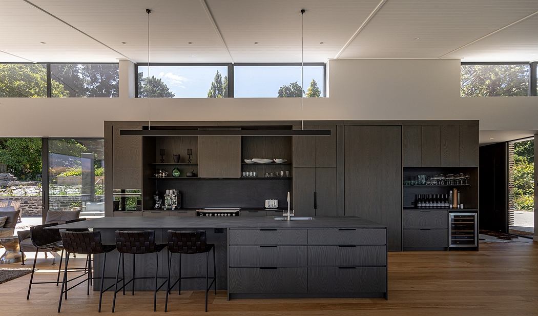 Sleek, modern kitchen with dark wood cabinets, minimalist design, and large windows.