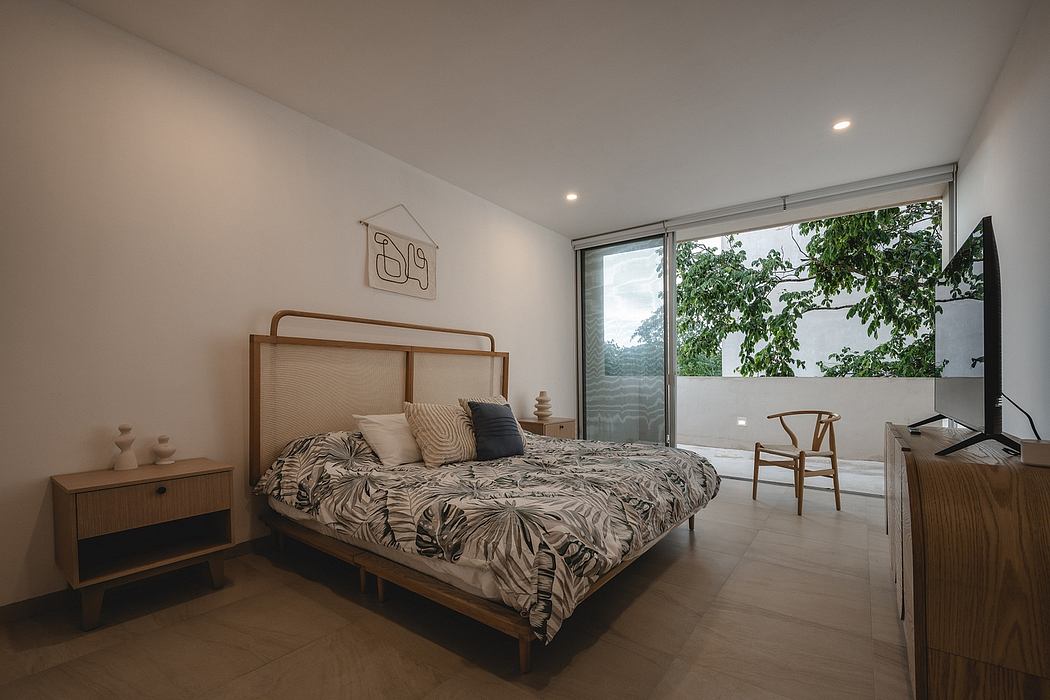 Spacious bedroom with large window, modern furnishings, and nature-inspired decor.