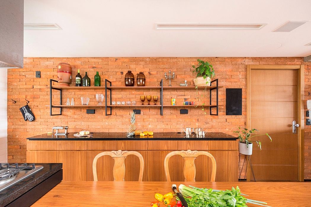 Warm-toned brick wall, open shelving, wooden cabinetry, and elegant dining chairs define this cozy kitchen.