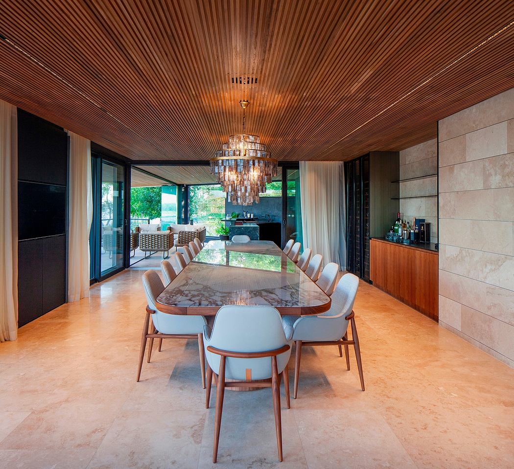 Elegant modern dining room with wooden ceiling, large chandelier, and marble table.